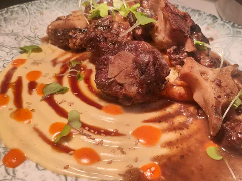 Rabo de toro guisado sobre puré, con la salsa reducida por encima